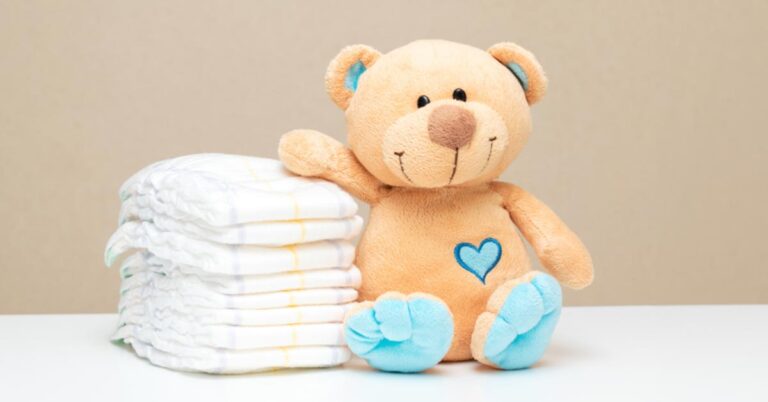Teddy Bear with a stack of diapers